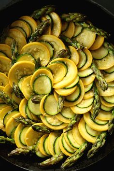 asparagus and squash in a skillet ready to be cooked