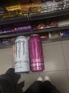 two cans of monster energy drink in a store