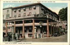 an old postcard shows people standing in front of a building