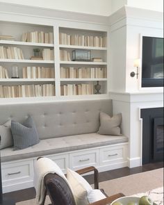 a living room filled with furniture and bookshelves