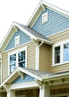 a large house with two story windows and white trim