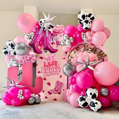 pink and black balloons, stars, and other decorations