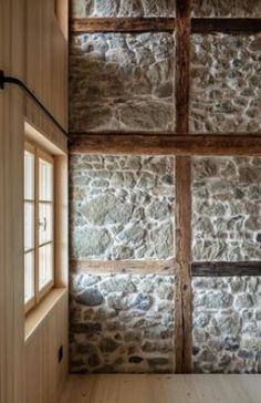 an empty room with stone walls and wooden floors