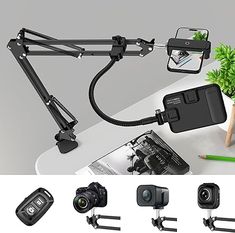 the camera and tripod attachments are attached to a desk with a plant in it