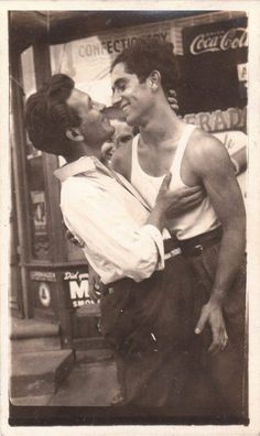 an old photo of two men kissing each other