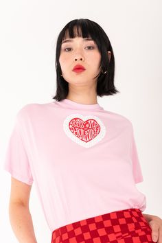 The "Kiss Me On Holiday" Unisex T-shirt. Rendered in 100% cotton jersey with puff printed graphics. Your new daily staple. Classic Standard Unisex Tee Fit Standard Sleeve Length with Ribbed Neck Pink 100% Cotton Jersey Puff Print Graphic Sizing Considered Standard Model is a size S wearing a Small. We use flash, film and polaroid photography, for best colour accuracy of the garment, please refer to the product imagery. Relaxed Fit Heart Graphic Tops For Streetwear, Spring Streetwear T-shirt With Heart Graphic, Pink Heart Graphic Short Sleeve T-shirt, Spring Graphic Tee With Heart Design, Pink Heart Graphic T-shirt For Streetwear, Spring Heart Graphic T-shirt For Streetwear, Heart Graphic T-shirt For Spring Streetwear, Graphic Tee With Heart Graphic For Streetwear, Pink Short Sleeve Top With Heart Graphic