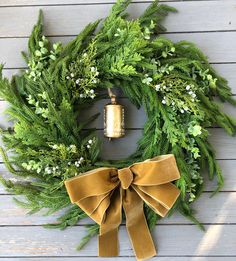 a wreath with a bell hanging from it