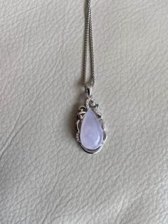 🌈 Water Drop Jadeite Jade Pendant, Light Lavender, S925 silver plate 🌷 Untreated Natural Jadeite/ Grade A Jade 🌷 Certified : YES 🌷 Jade from Myanmar/ Burma 🌷 100% handmade carving 🌷 Dimensions : ~18.6 x 10.6 x 8 mm 🌷 Color : Light Lavender 🌷 Including with S925 silver plate 🌷 The chain in the photos is for reference only, will not be included in the shipment 🌷 Free standard shipping from Hong Kong with tracking included 🌷 Take approximately 7-21 days to arrive worldwide ❤️ In Chinese Elegant Natural Chalcedony Gemstones, Elegant Silver Drop Gemstones, Elegant Silver Teardrop Pendant Gemstone, Silver Natural Stones For Wedding, Silver Gemstones With Natural Stones For Wedding, Formal Silver Kunzite Jewelry, Exquisite Silver Jade Jewelry, Elegant Round Chalcedony Gemstones, Lavender Green