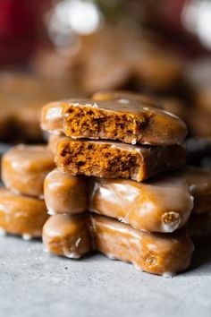 a stack of glazed donuts sitting on top of a counter