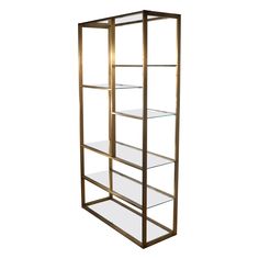 a tall metal shelf with glass shelves on each side and gold trim around the bottom