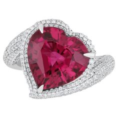 Elegant and exquisitely detailed 18K White Gold Ring, with 6.8 Cts Heart Shape Rubellite set in center and Surrounded by Micro pave Diamonds, weighing approx. 1.1 CT's. total carat weight to further enhance the beauty of the ring. Beautifully Hand crafted in 18 Karat White Gold Product Details: - Primary Stone: - Rubellite Primary Stone Shape: - Heart Primary Stone Cut: - Faceted Primary Stone Size: - 12.70X12.55MM Primary Stone Weight: - 6.8 Cts Diamond: GH/SI Total Diamond Weight: 1.1 Cts Birthstone Jewelry/ Jewelry Handmade /jewelry Wife Gift/Lovers Gift Valentine Gift/Girlfriend Gift handcraft jewelry. July Birth Stone Jewelry mother Day special jewelry pendant birthday Gift and Anniversary gift etc. This Beautiful Pendant Adds a Touch of Luxury to your neck. While Remaining Sparkling Valentine Gifts For Girlfriend, Mothers Day Special, Special Jewelry, White Gold Ring, Stone Cuts, Micro Pave, San Valentino, Birthstone Jewelry, Diamond Studs