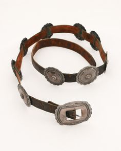 A special Native American concho belt with 9 stamped individual conchos and a buckle. Sterling or coin silver depending on its age. This is most likely from 1930/40’s. One concho is loose at copper backing (see photo). Otherwise in great, wearable condition. MEASUREMENTS Fits 32-39 inch (holes can be added to adjust further) Width of belt 7/8 inch Conch size 1 7/8 inches Buckle size 2 5/8 x 2 1/4 inches Total length 43 inches Vintage Formal Concho Belt Buckles, Traditional Leather Belt With Concho, Traditional Silver Concho Belt, Classic Brown Belt With Concho Details, Vintage Silver Concho Belt Buckles, Vintage Silver Concho Belt, Concho Belt, Conch, Leather Belt