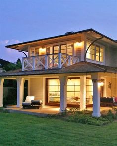 a large white house sitting on top of a lush green field