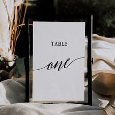 a table sign sitting on top of a bed