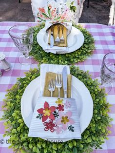 the table is set with flowers and place settings for two people to sit down at