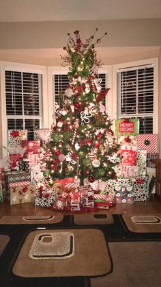 a decorated christmas tree with presents under it