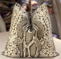 a snake skin pillow sitting on top of a table