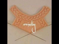 an orange knitted sweater with the word ervingjaf on it and two knitting needles