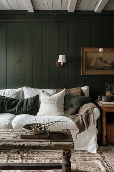 a living room filled with furniture and green walls