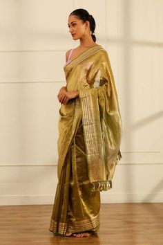 Olive green handwoven tissue silk saree with a floral pattern border. Comes with an unstitched blouse piece. - Aza Fashions Traditional Slub Silk Pre-draped Saree For Celebration, Green Chanderi Pre-draped Saree For Celebration, Elegant Green Handloom Pre-draped Saree, Festive Pista Green Handloom Pre-draped Saree, Festive Cotton Silk Pre-draped Saree For Celebration, Pista Green Raw Silk Pre-draped Saree For Diwali, Celebration Handloom Chanderi Pre-draped Saree, Pista Green Tissue Silk Saree Blouse Piece, Unstitched Pista Green Cotton Silk Pre-draped Saree