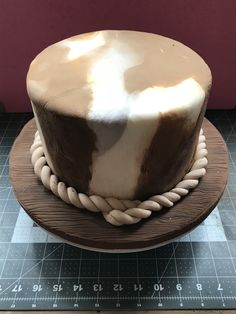 a chocolate cake sitting on top of a wooden plate