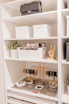 a white closet filled with lots of boxes and other items in it's shelves