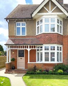 a large brick house with white trim and windows