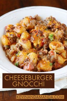 a white bowl filled with cheeseburger gnocchi on top of a wooden table