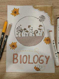 some markers and pens are sitting on a paper with the words biology written in it