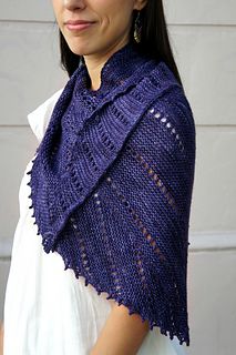 a woman wearing a purple knitted shawl