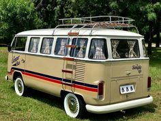 an old vw bus is parked in the grass with its roof rack on top