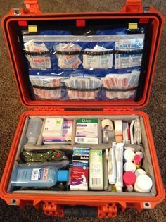 an orange case filled with medical supplies on the floor