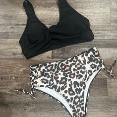 Nwt. Size Large. Top Has Removable Pads. Bottom Is High Waisted With Moderate Coverage. The Cheetah 2 Piece Bikini Swimsuit Is A Perfect Combination Of Classic Style & Modern Sensibility. An Animal Print Bottom Balances Out With A Solid Black Top For A Look That's Both Laidback And Chic. Black Ruched Swimwear For Pool, Black Lined Tankini For Vacation, Vacation-ready Black Lined Tankini, Black Lined Tankini For Beach Party, Black Ruched Swimwear For Sunbathing, High Waist Black Swimwear For Beach Party, Black High Waist Swimwear For Beach Party, Black High-waist Swimwear For Beach Party, High-waist Black Swimwear For Beach Party