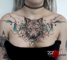 a woman with tattoos on her chest has a wolf tattoo on her left shoulder and is wearing a black dress