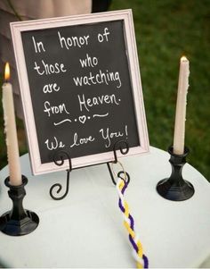 a chalkboard sign on top of a table with candles