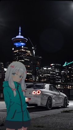 a woman standing in front of a car at night with the city lights behind her