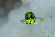 This is a beautiful Peridot from Pakistan set in Sterling Silver. This amazing stone has the perfect lime green color that many want with a great luster, and clarity!. Peridot is one of those underrated stones that has a quite remarkable history. Peridot is August's Birthstone. This nicely sized 9mm X 7mm Oval Peridot weighs 2.220cts and will go great with most styles or occasions. They will even go good with some of our Peridot Earrings located in our Gemstone Stud Earring Section. Please feel Classic Green Gemstone With Center Stone, Green Gemstones With Round Cut Accent Stones, Green Large Gemstones For Anniversary, Large Green Gemstones For Anniversary, Large Oval Green Gemstones, Anniversary Large Green Gemstones, Round Peridot Gemstones With Accent Stones, Round Green Peridot Gemstones, Verde Lima