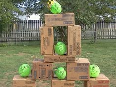 several boxes stacked on top of each other with green balls in the shape of smiley faces