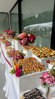 a long table filled with lots of different types of food on it's sides