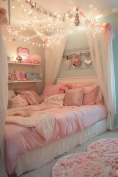 a bedroom with pink and white decor on the walls, lights strung over the bed