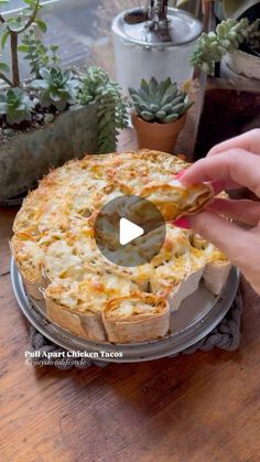 someone is placing a piece of pizza on top of the pie