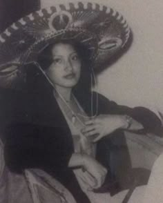 an old photo of a woman wearing a sombrero