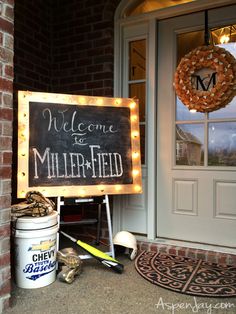 a welcome to millerfield sign is lit up outside the front door with lights