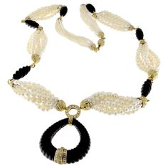 Description: This sophisticated necklace, originating from the 1960s, features a unique design combining white South Sea pearls, cut onyx elements, and 18 karat yellow gold enriched elements. It exemplifies timeless elegance and craftsmanship, making it a standout piece from its era. Specifications: Material: 18 Karat Yellow Gold Design: Original from the 1960s Gold Weight: 87.40 grams Diamonds: Total Weight: 7.67 carats Color: H-G Clarity: VVS1-VVS2 Gemstones: Pearls: White South Sea pearls in Art Deco Pendant Necklace, White Gold Pendant Necklace, Vintage Pendant Necklace, Pearl And Diamond Necklace, Bling Necklace, Coral Pendant, Gold Rush, South Sea Pearls, Sea Pearls