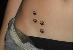 a woman's stomach with small paw prints on the bottom of her stomach,