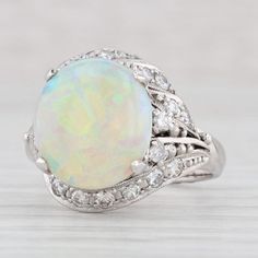 Gemstone Information: - Natural Opal - Size - 10.8 x 12 mm  Cut - Oval Cabochon Color - Multi-Color - Natural Diamonds - Total Carats - 0.43ctw Cut - Round Brilliant Color - G - H Clarity - VS2 - I2 Metal: 900 Platinum Weight: 6.9 Grams  Stamps: pt 900 Face Height: 15.2 mm  Rise Above Finger: 9.6 mm Band / Shank Width: 2.5 mm This ring is a size 6, but it can be resized down 1 size for a $50 fee or up 2 sizes for a $150 fee. If you would like your ring resized, please select the appropriate fee Exquisite Oval Platinum Gemstones, Formal Multi-stone Oval Cabochon Jewelry, Fine Jewelry Diamond Cabochons For Wedding, Anniversary Gemstone Cabochons, Anniversary White Gold Gemstone Cabochons, Oval Cabochons With Center Stone For Anniversary, White Gold Gemstone Cabochons Fine Jewelry, Fine Jewelry White Diamond Gemstones, White Multi-stone Platinum Jewelry