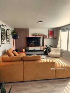 a living room filled with furniture and a flat screen tv