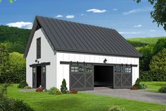 a white barn with a black roof and two garage doors on the side of it