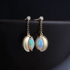 Dainty Drop Earrings with Diamond and Marquise Australian Opal 18K Yellow Gold. Free Domestic USPS First Class Shipping! Free Gift Bag or Box with every order!Opal—the queen of gemstones, is one of the most beautiful gemstones in the world. Every piece of opal is unique in its own ways and patterns. We only use high-quality Natural Opals (NO synthetics or imitations) for our jewelry. ----------------------------------------------------------------------------------------------------ABOUT THIS PRODUCTSolid 18k Yellow GoldAustralian Solid Opal: 0.30 ct2 Diamonds: 0.012 ctMetal Color: Golden Opal Color: Rainbow ColorsOpal Size: 6x3 mmEarring Size: 16x6 mm Occasion: Engagement / Wedding----------------------------------------------------------------------------------------------------RING RE-S Exquisite Gold Earrings With Gemstone Accents, Gold Plated Earrings With Gemstone Accents As Gift, Opal Earrings For Wedding, Opal Jewelry In Yellow Gold With Matching Earrings, Gold-plated Yellow Gold Earrings With Gemstone Accents, Yellow Gold Opal Jewelry With Matching Earrings, Luxury Yellow Gold Opal Jewelry, Opal Yellow Gold Earrings For Gifts, Yellow Gold Opal Earrings For Gifts