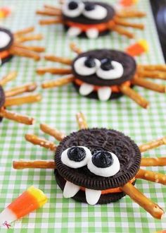 some cookies decorated to look like bugs with candy sticks in the middle and eyes on them